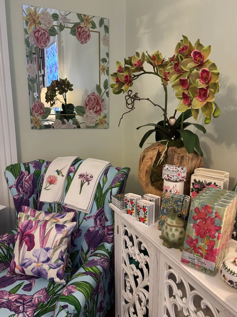 Bloom Room shop with flower-decorated mirror, towels, and other products